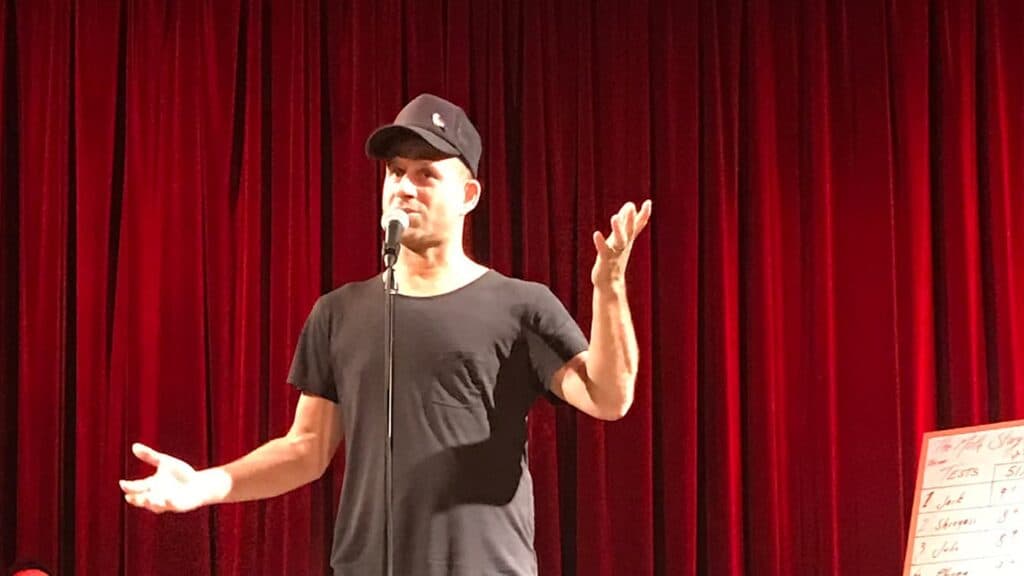 Eran Thomson performing at a The Moth storytelling event